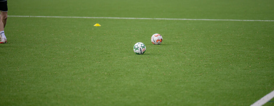 Hamburg, Germany - Februrary 24, 2024: Derbystar footballs on an artificial turf football pitch