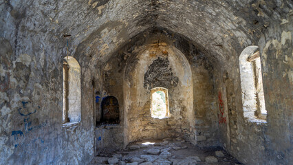 Fototapeta na wymiar Ruins of Byzantine church on island Camellia in Aegean Sea, Turkey. Boat trips in Aegean Sea. Wild abandoned island