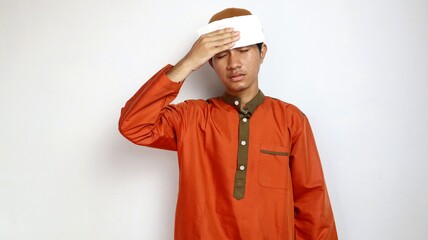 asian muslim man is sick and using tissue