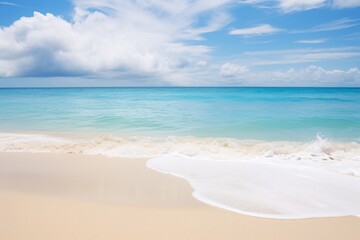 Fototapeta na wymiar a beach with blue water and clouds