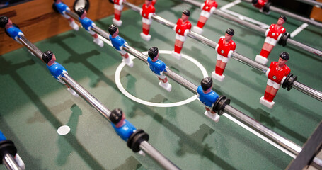 Table football. Green table with little players. Playing football table game.