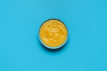 Apple sauce bowl above view, isolated on a blue background