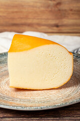 Gouda cheese. Dairy products. Slices of Gouda cheese on a plate. Close up