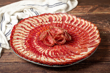 Beef pastrami. Dairy products. Slices of bacon on a plate