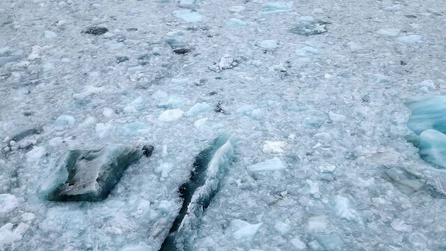 Slow pan from pack ice up to a view of the Hubbard Glacier on a cloudy day. 