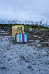 Abandoned beach chairs by trash