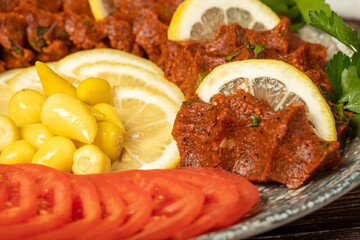 Çiğ Köfte. Traditional middle eastern cuisine. Çiğ köfte or turkish raw meatballs ready to serve on a plate. Close up
