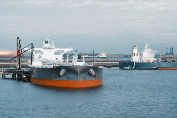 Marine Loading Arm And Crude Oil Carrier Tanker In The Harbour Engaged In Cargo Operations © I am from Mykolayiv