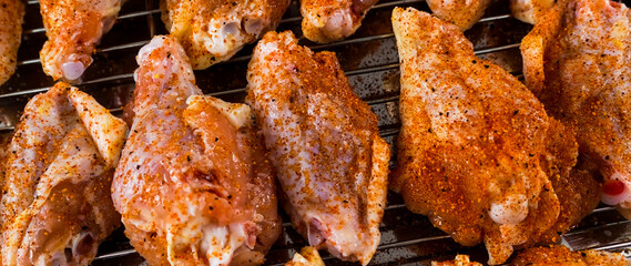 Chicken wings barbecue roasted cooking with spices. Fried chicken wings, homemade, food for restaurant, menu, advert or package, close up. American cuisine. - 746597279