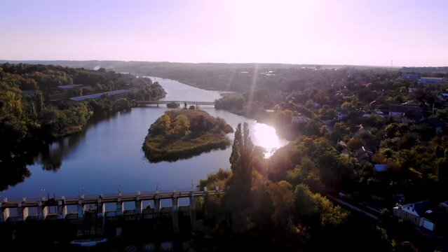 Aerial view. The picturesque Ros river at sunset. Dam, bridges and beautiful islands. Incredible landscapes of Ukraine. Cherkasy region, Ukraine.