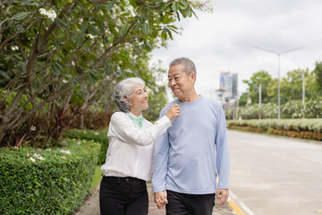 Couple in the park near home to relax, health and exercise in love sports, old man and senior woman taking a walk outdoors together in the morning