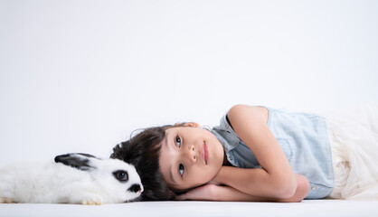 Smiling little girl and with their beloved fluffy rabbit, showcasing the beauty of friendship...