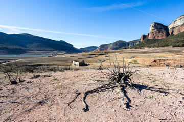 Lack water Sau Reservoir. The swamp is at very low water levels due to lack of rain. Desertification, climate change, environmental problems, drought. Barcelona, Spain