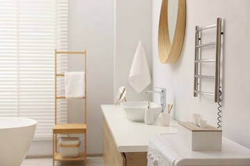 Stylish bathroom interior with heated towel rail and vanity