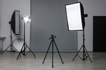 Modern light grey photo background and professional lighting equipment in studio