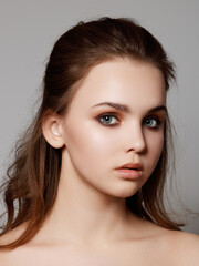 Fototapeta premium Portrait of young beautiful woman with perfect smooth skin isolated over white background. Happy beauty woman looking away isolated on background. Beauty woman face healthy skin care