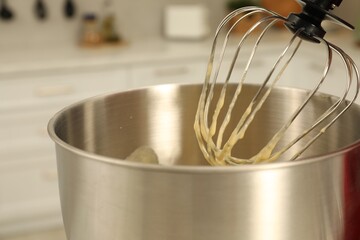 Modern mixer with cream in kitchen, closeup