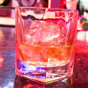 glass of cola with ice cubes