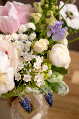 a beautiful delicate spring bouquet of tulips, buttercups and muscari, floral arrangement	