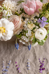a beautiful delicate spring bouquet of tulips, buttercups and muscari, floral arrangement	
