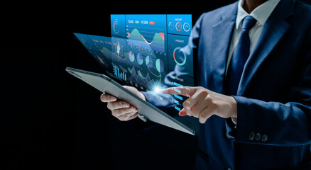 Businesswomen analyze chart data business on a visual screen dashboard, technology devices and screens visible in the background, financial planning, market research, and the stock market.