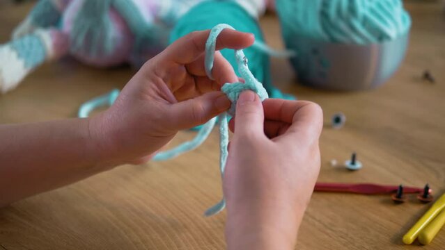Elderly female hands crocheting stuffed toys, small family business