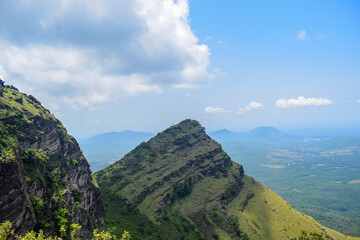 Grassy hills and the blue sky nature background. Springtime landscape.