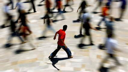 The feeling of loneliness of a person represented by the central position in a blurry crowd