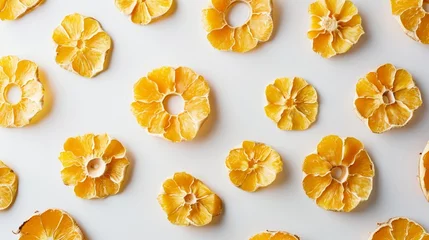 Foto op Plexiglas Golden clusters of dried mango slices and pineapple rings arranged against a clean white backdrop, highlighting their tropical sweetness. © baloch