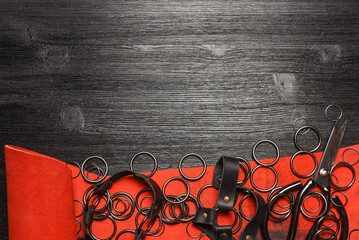 Leather piece and metal rings furniture on the wooden black table background. Leather craft...