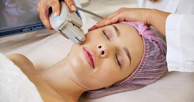 Beautiful woman receiving facial microcurrent treatment at spa salon. Beautician using electrical impulses for facial procedures. Woman in spa salon. Woman in a spa salon on cosmetic procedures.