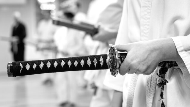 Traditional Japanese katana sword in hands, close-up view.