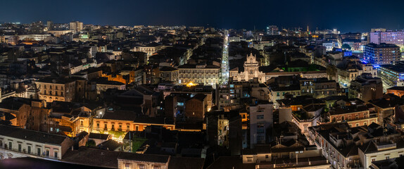 Fototapeta na wymiar Night aerial view from the center to the sea of the city of Catania, Sicily, Italy
