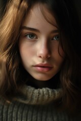 Fototapeta premium A woman with long hair wearing a turtle neck sweater. Suitable for fashion and lifestyle themes