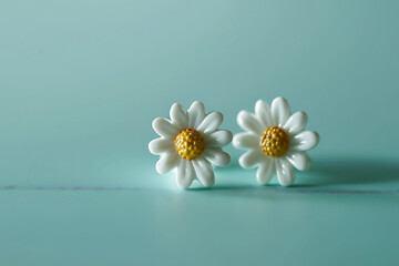 daisy stud earrings on turquoise background in the st