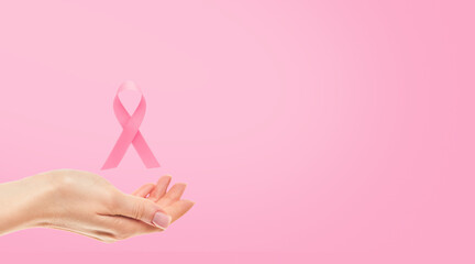 Pink Breast Cancer Awareness Ribbon. Female hand holding pink ribbon flying symbol of fight against breast cancer. Breast cancer awareness and October Pink day, world cancer day. Top view. Mock up.