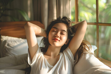 Asian woman waking up from good sleep in morning relaxing in bedroom at room.