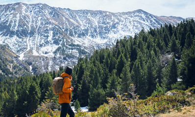 man backpack looking snow mountain