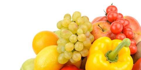 Fruits and vegetables in a wicker basket isolated on a white. Free space for text. Wide photo.