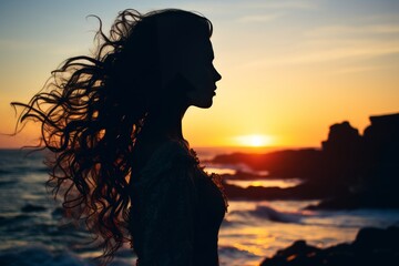 Fototapeta premium Stunning double exposure of womans silhouette with amazing ocean sunset in background
