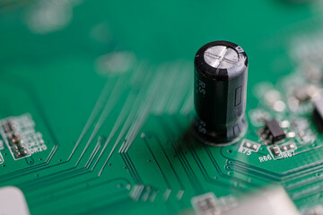 A cylindrical capacitor on a printed circuit board.
