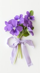 A bunch of purple flowers with a purple ribbon