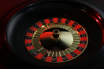 Roulette wheel with ball on black table, closeup. Casino game