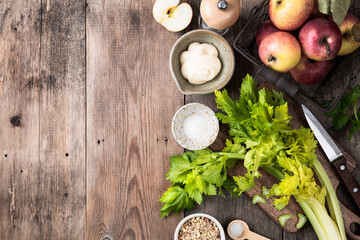 Apples, celery, lime, walnut and mayonnaise on a wooden background