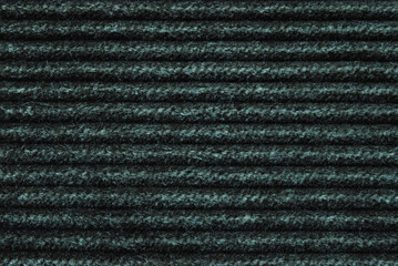 Dark green corduroy fabric texture as background