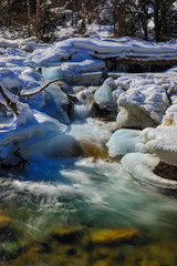 Mountain river in a winter time with frozen ice