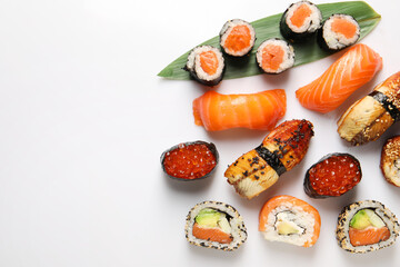 Different tasty sushi rolls on white background, flat lay. Space for text