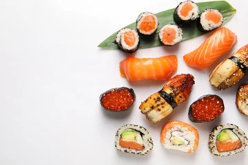 Stoff pro Meter Different tasty sushi rolls on white background, flat lay. Space for text © New Africa