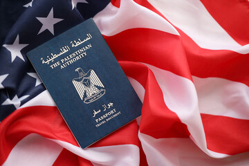 Fototapeta premium Blue Palestinian Authority passport on United States national flag background close up. Tourism and diplomacy concept