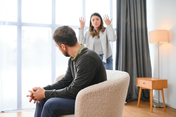 Abusive wife arguing husband, jealous distrustful dominant woman shouting at sad man